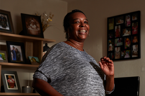 Smiling black woman doing exercise at home